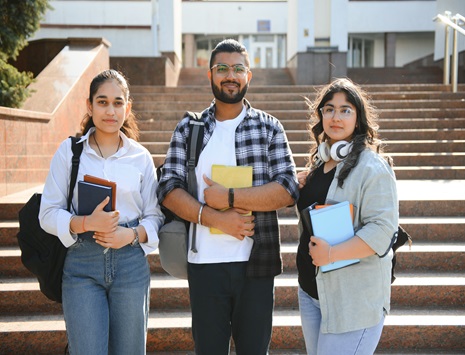 Students standing with books in hands