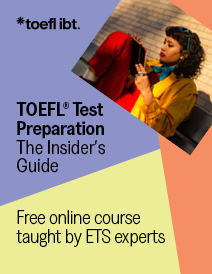 A young woman with sunglasses on her head sits outside studying